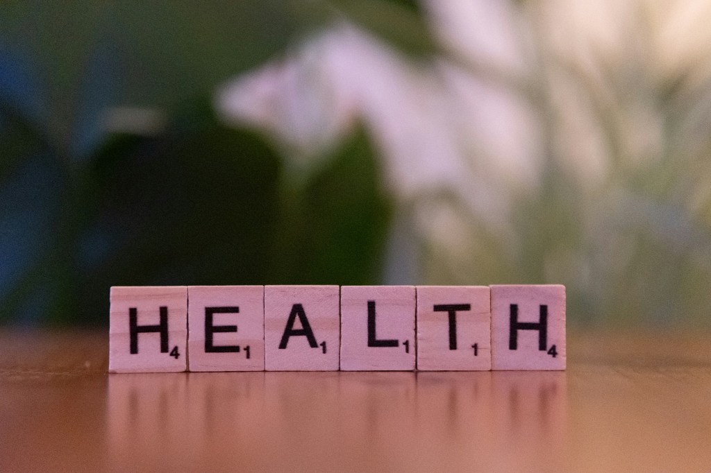 a-wooden-block-spelling-the-word-health-on-a-table-